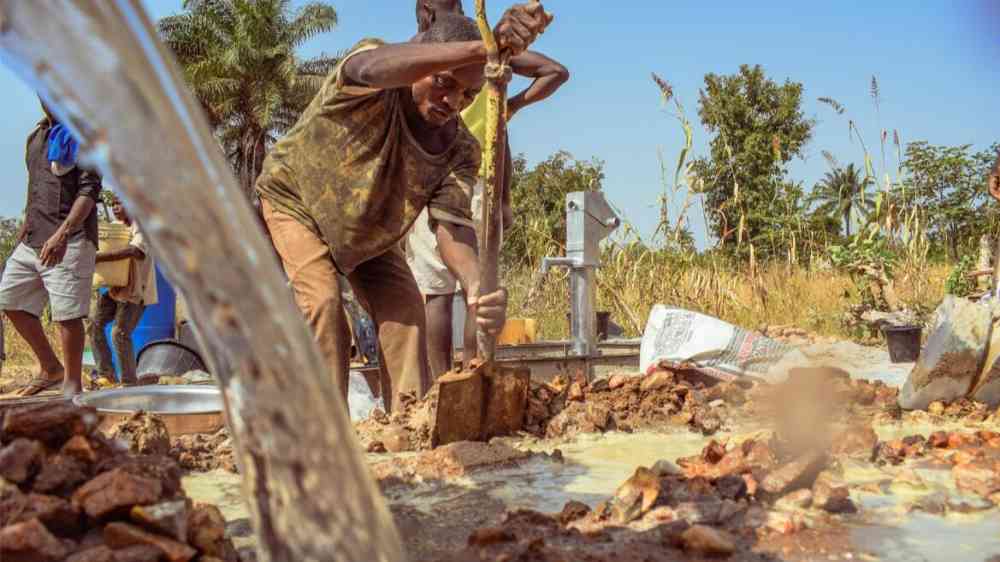 A team of villagers construct a well in Jos East, Plateau State, Nigeria