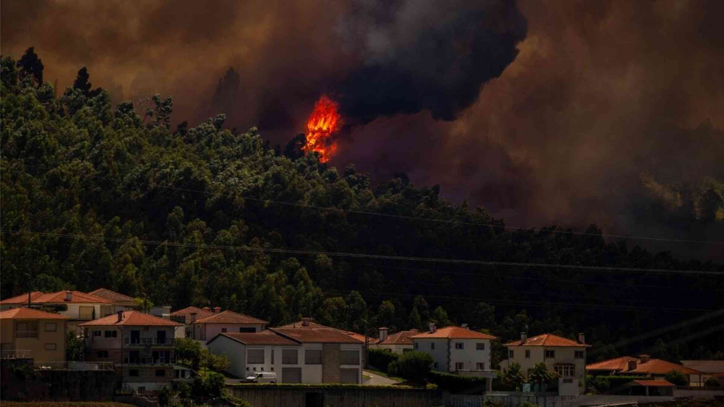 A blazing wildfire starts to encroach on residential areas in Braga, Portugal