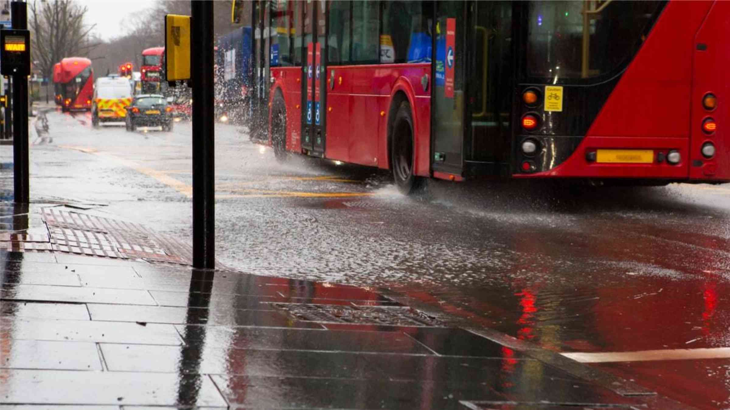 Bus driving through a puddle