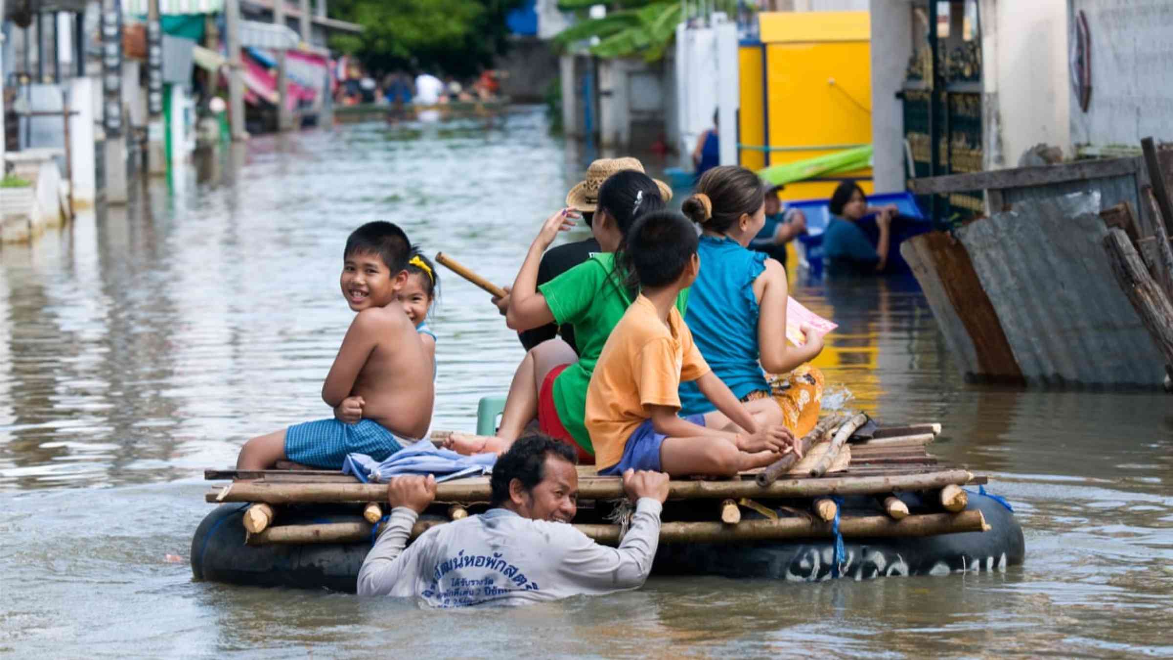 Villagers going home on an improvised raft during the monsoon flooding in Thailand, 2010