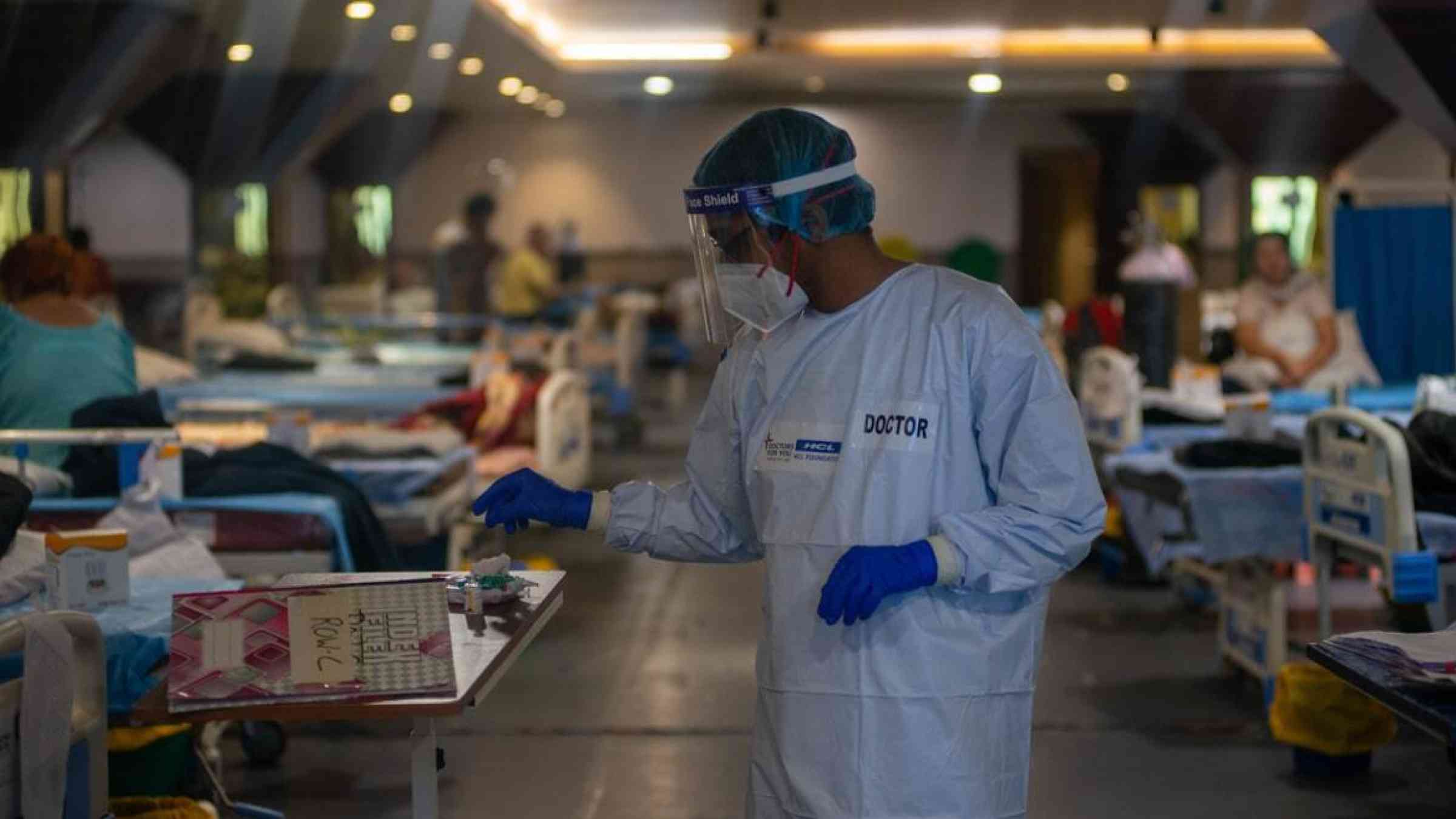 A doctor goes about in an infectious diseases ward set up in New Delhi, India at the height of COVID-19
