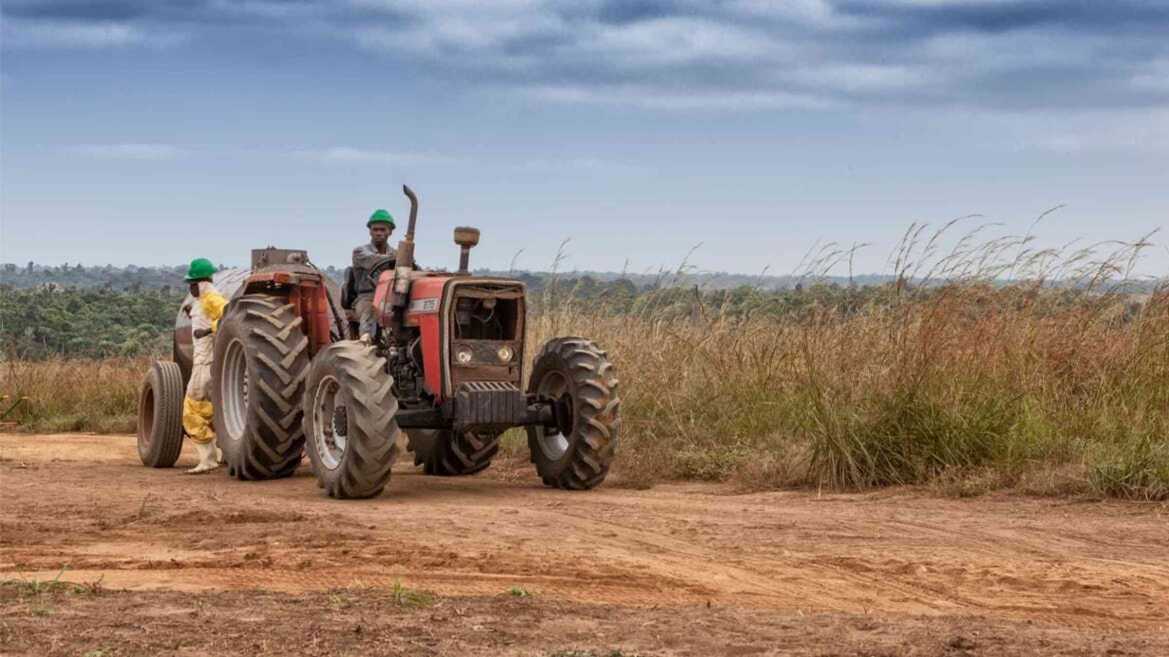 An farmer crosses his field on a tractor in Cabinda, Angola