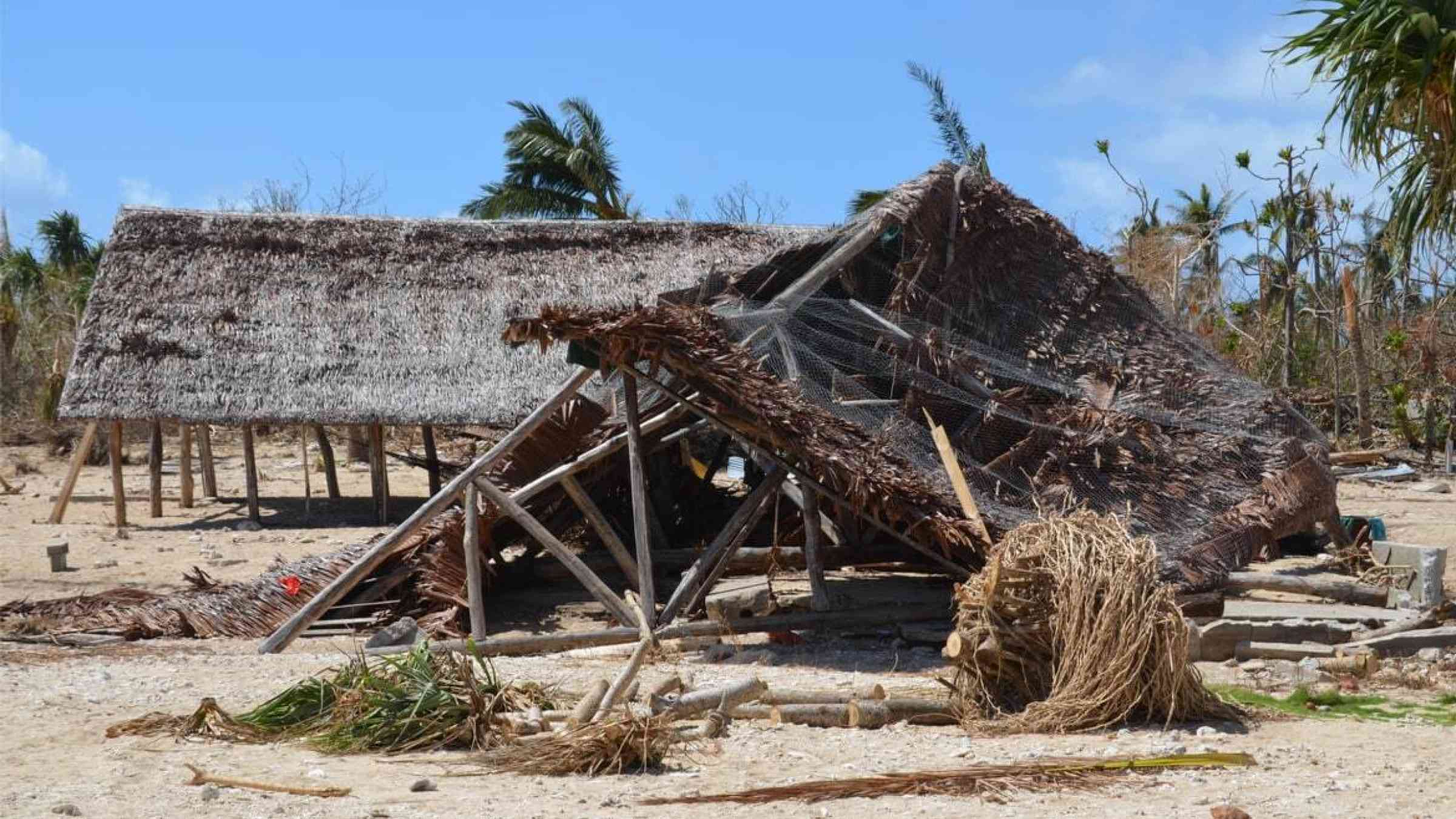 A hut lies toppled after a cyclone hit Vanuatu