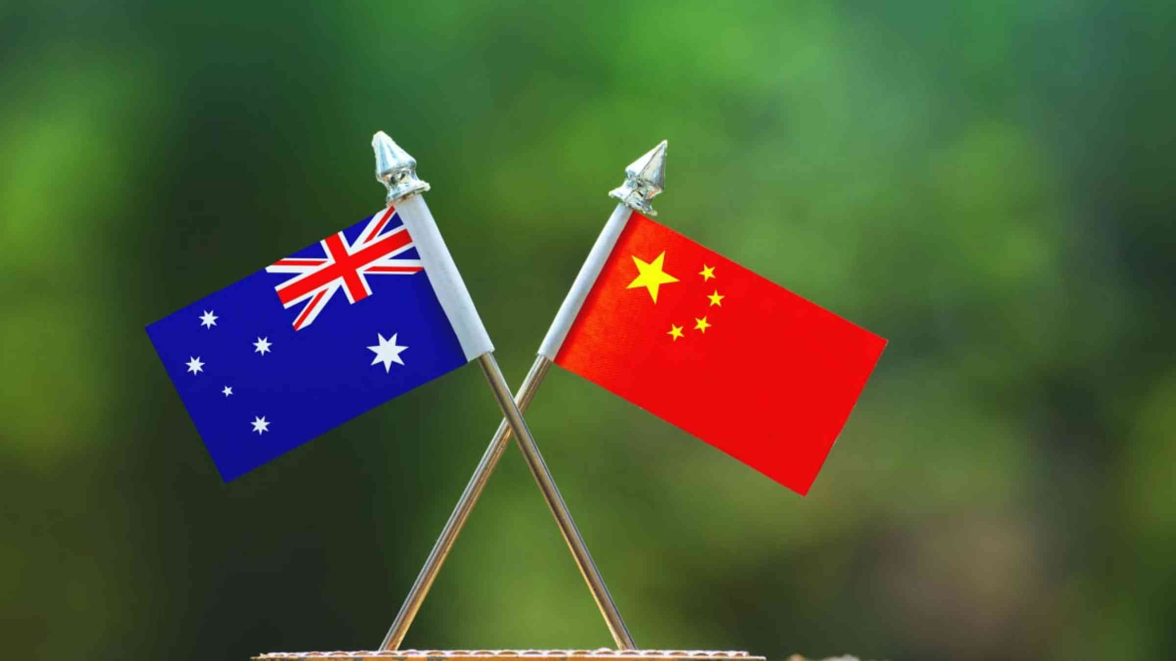 China and Australia small flag with blur green background