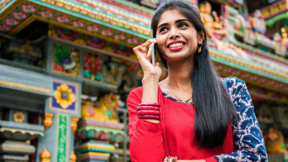 A woman talking on the phone in the streets in Bangladesh.