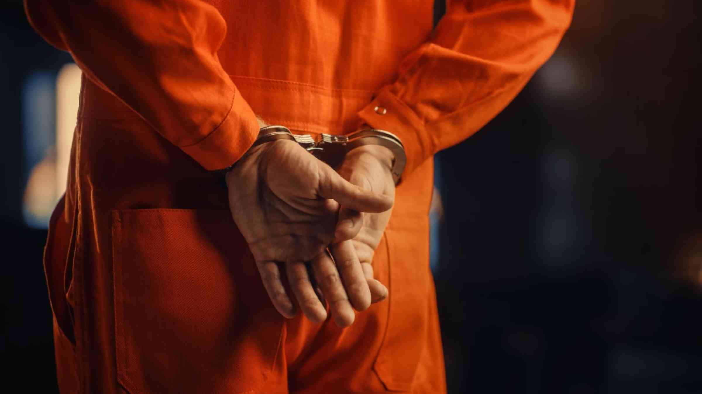 Prison inmate with handcuffs.