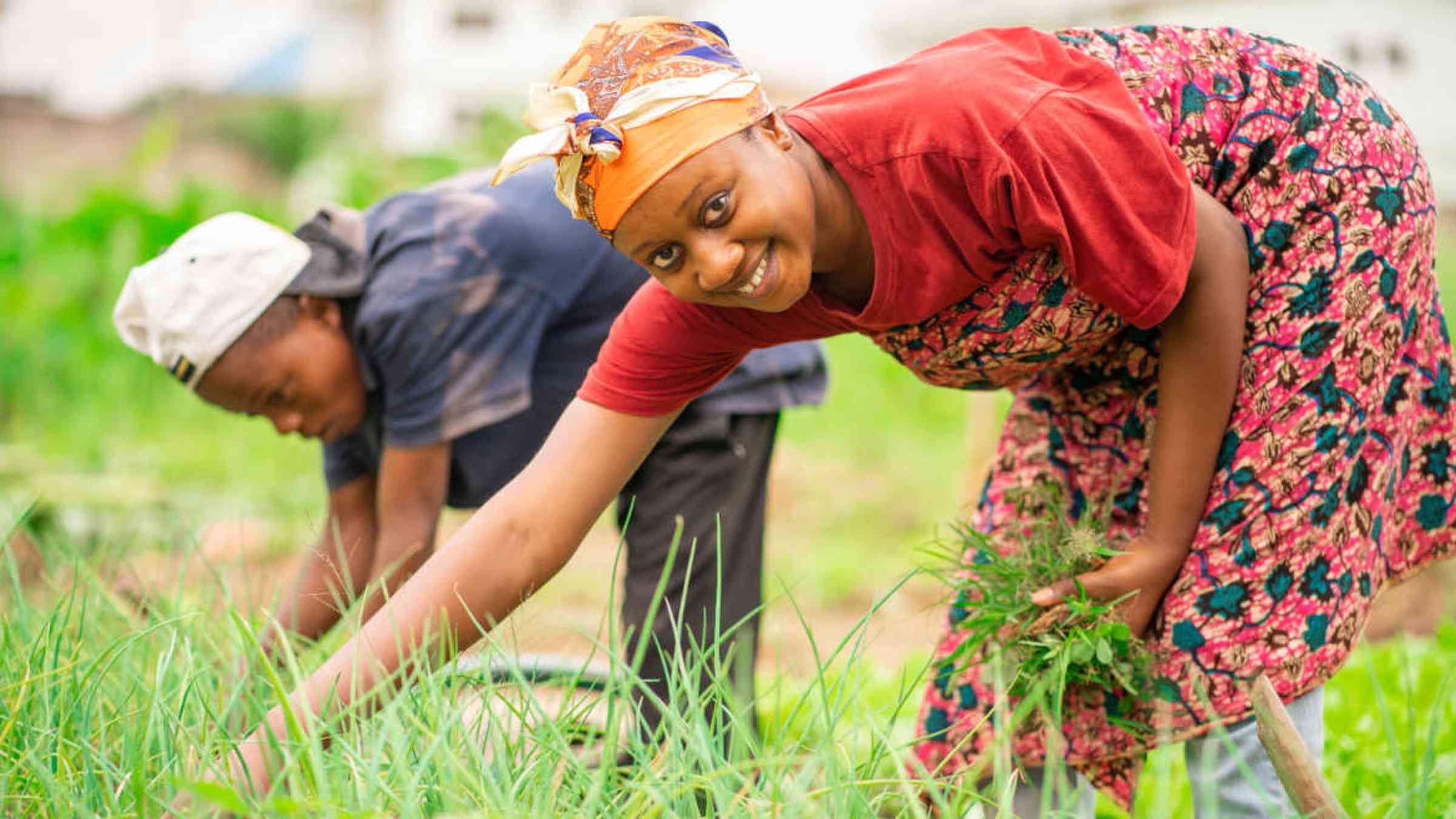 African woman and a boy in a field