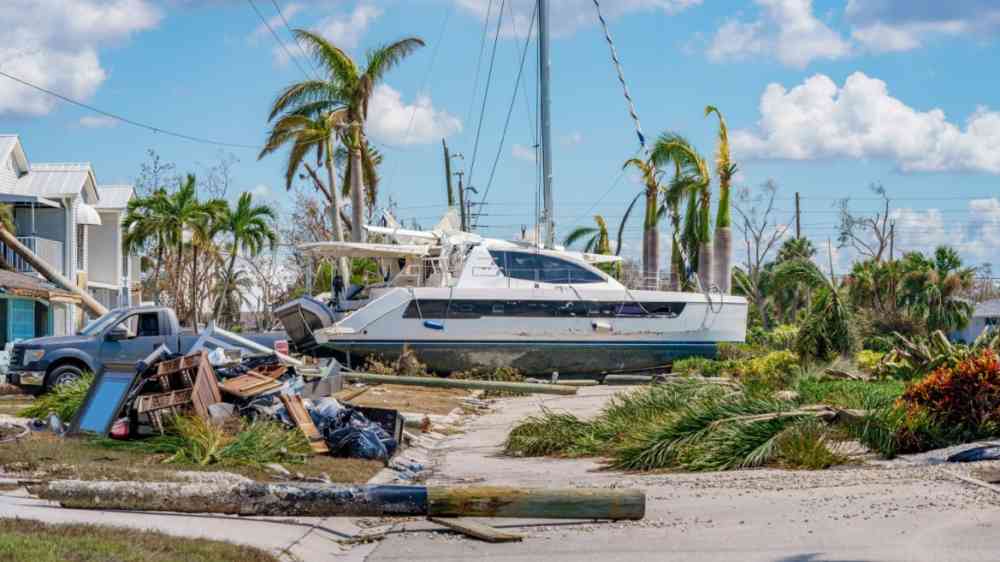 Catamaran resting on resting on a residential neighborhood street after Hurricane Ian