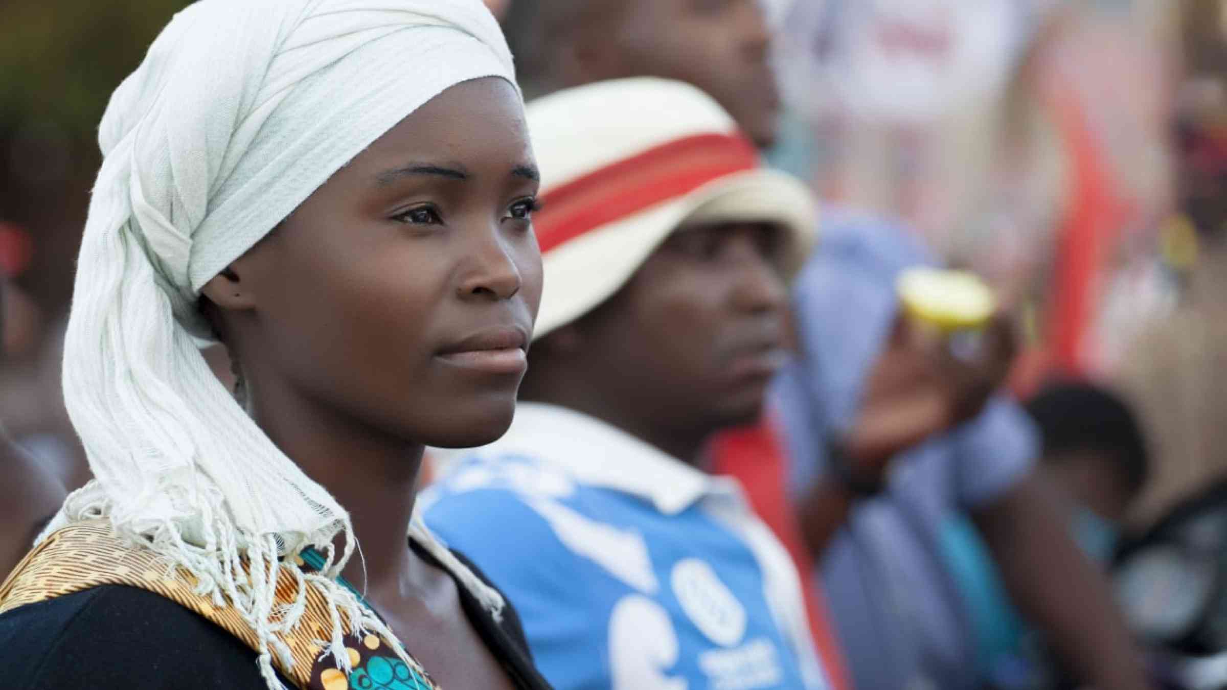 Young woman wearing a traditional scarf on her head attends a public event in Northern Mozambique