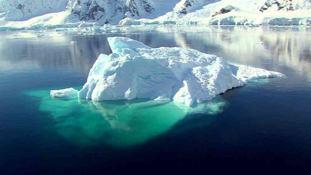 An iceberg floats in the sea