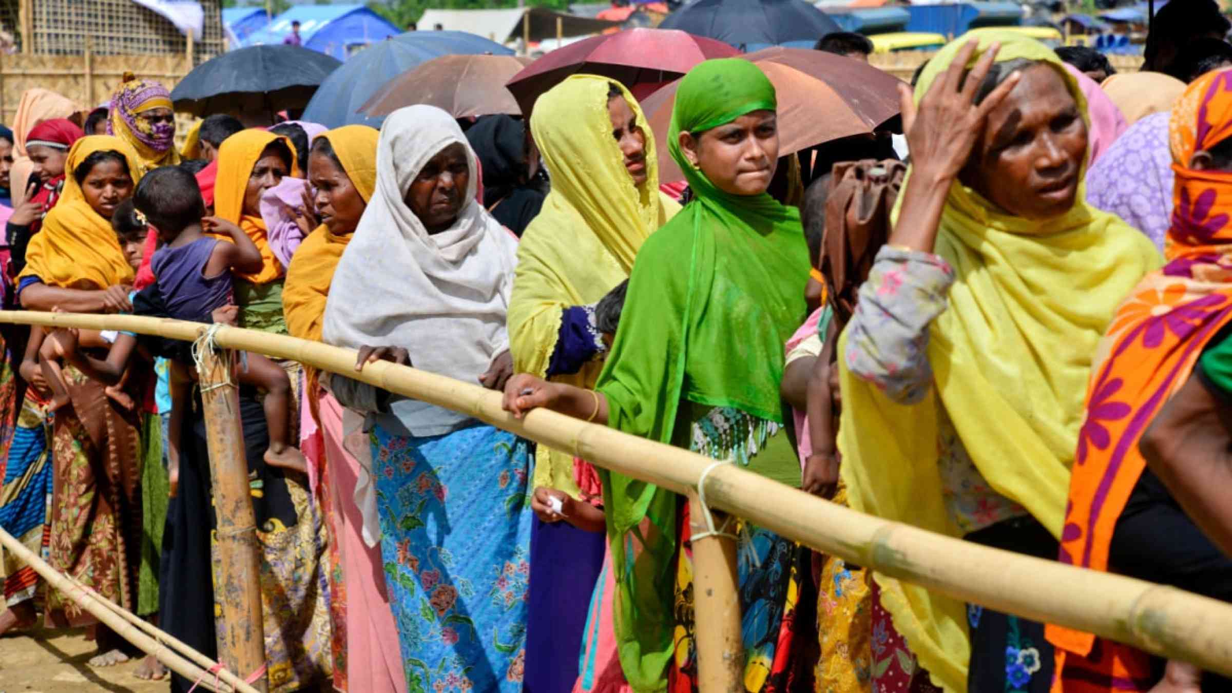 Rohingya refugee women wait to collect relief aid at the palongkhali makeshift Camp in Cox's Bazar, Bangladesh, on October 06, 2017