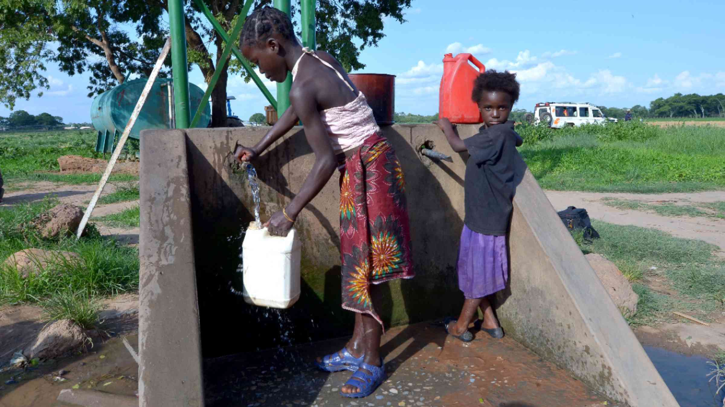 African children fetch water from a water source