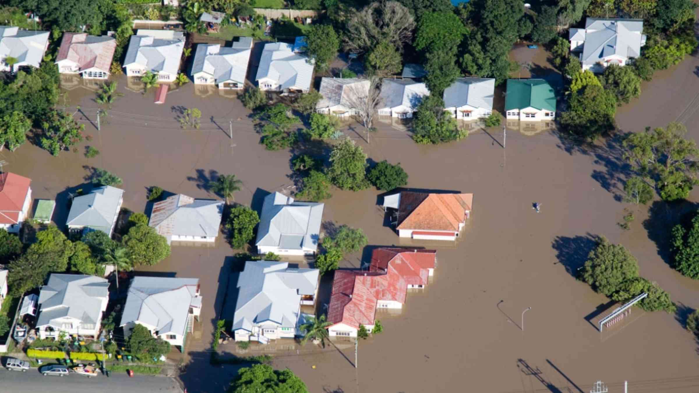 Aerial View of homes under water in Australia's flooding disaster. Also features paddlers surveying damage.