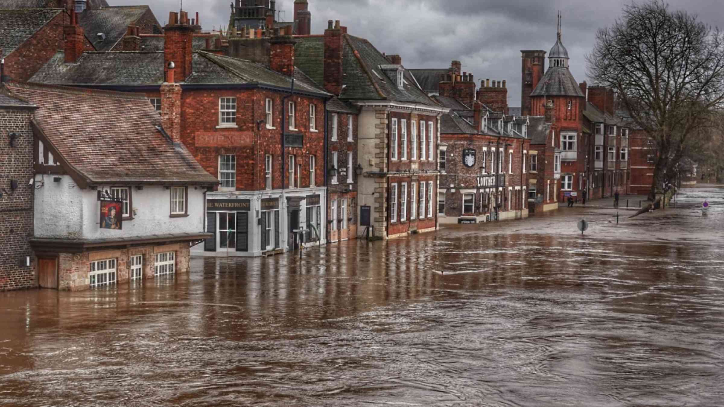 Flooded street in the city of York in the United Kingdom. The first story of the red brickstone houses is under water.