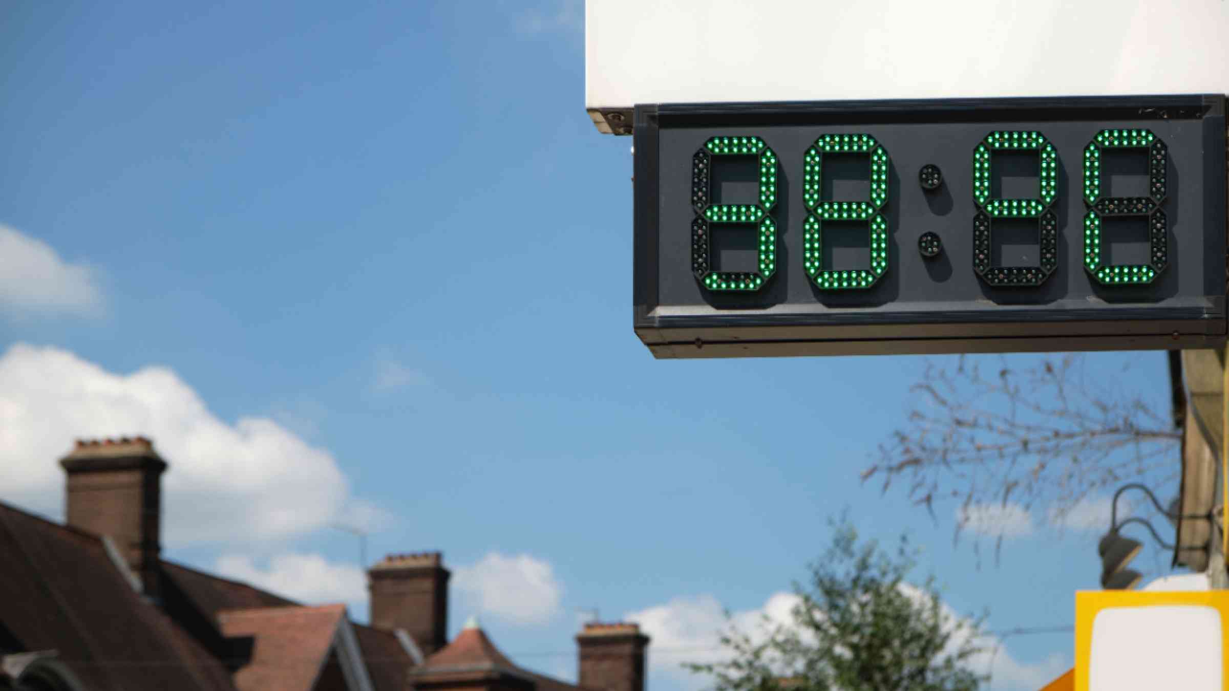 Digital thermometer showing a high temperature in a town