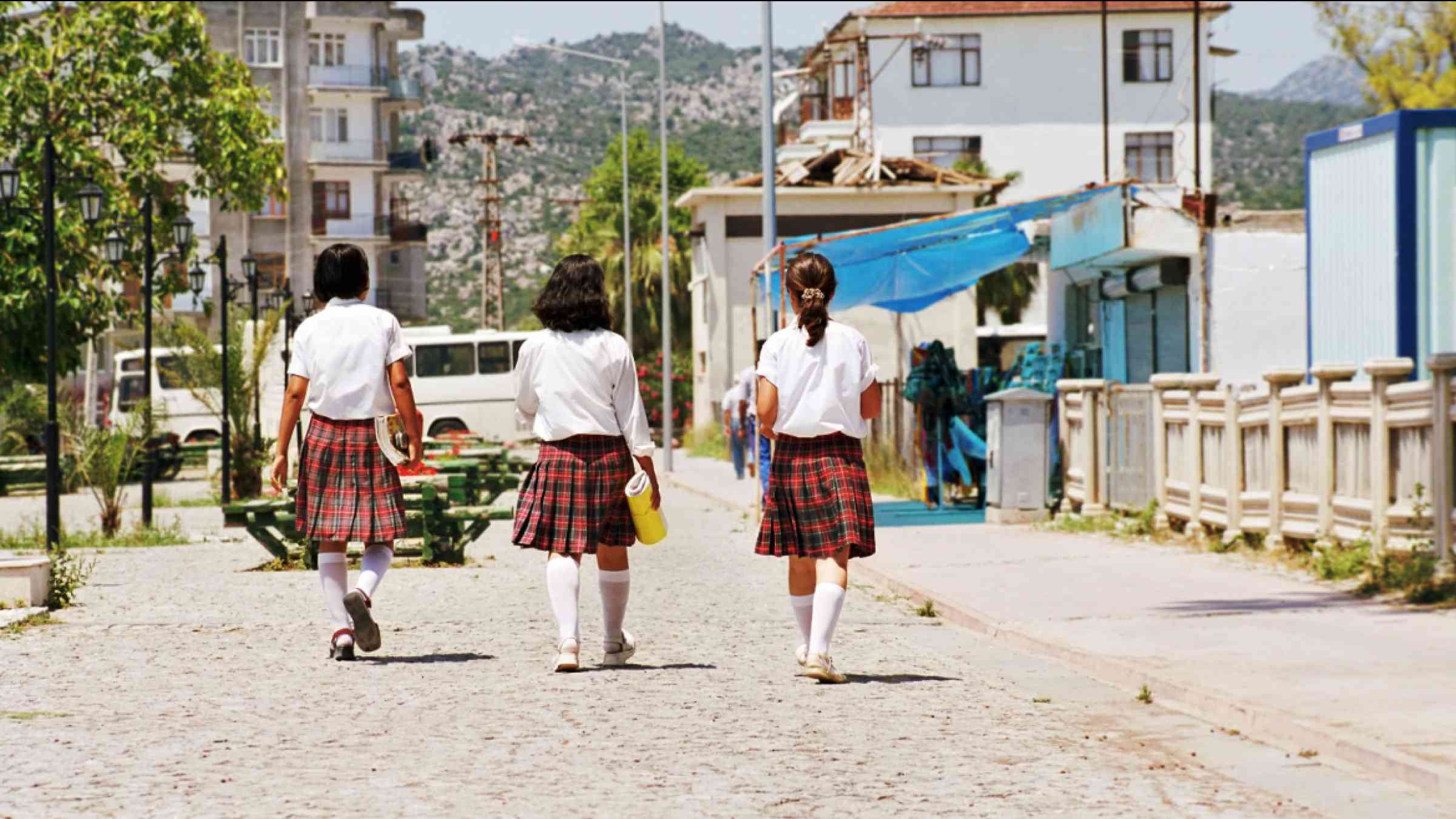 Turkish schoolgirls in uniform walking in a street
