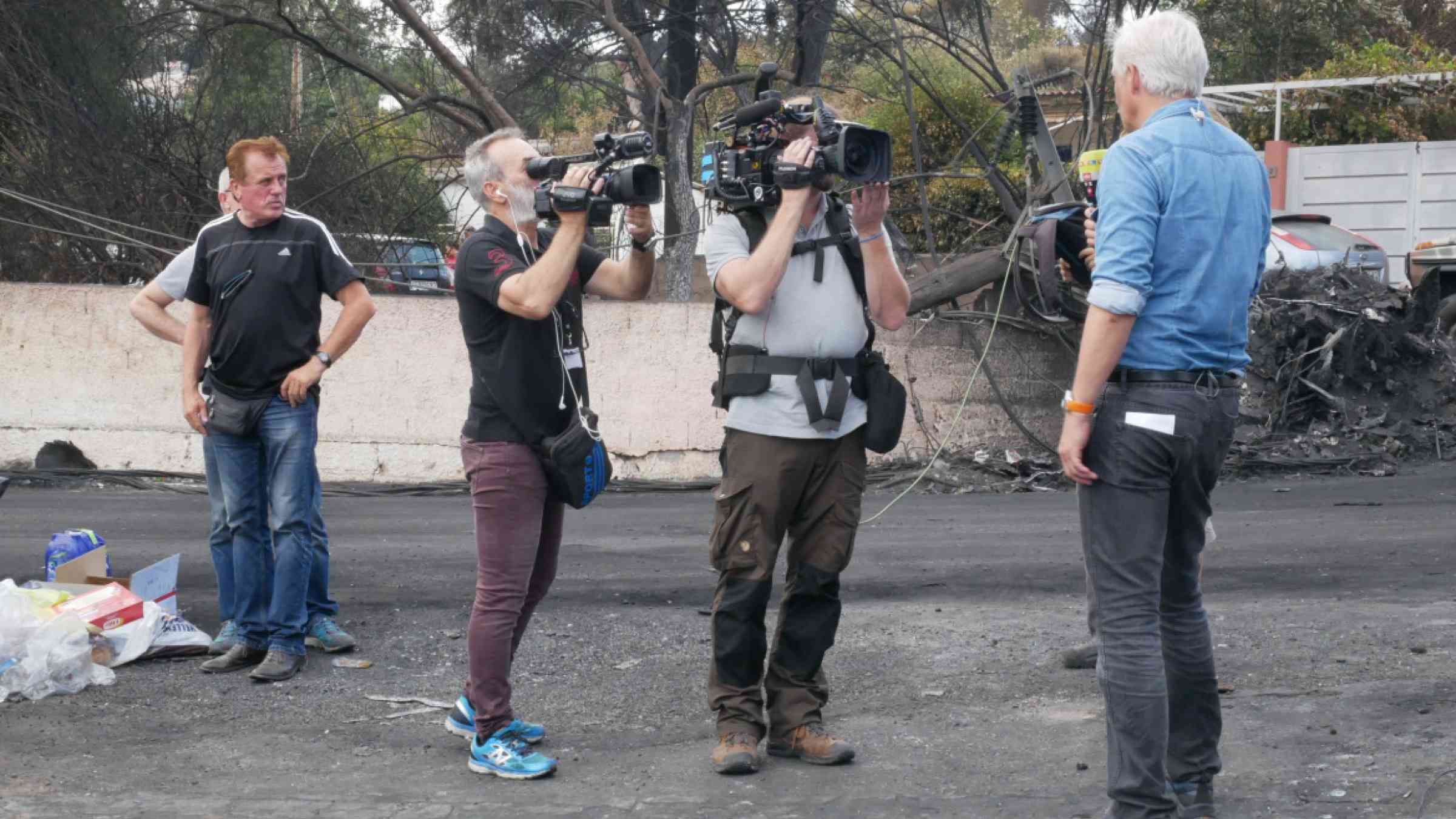 Journalist is reporting about the wildfire disaster in Mati near Athens in 2018