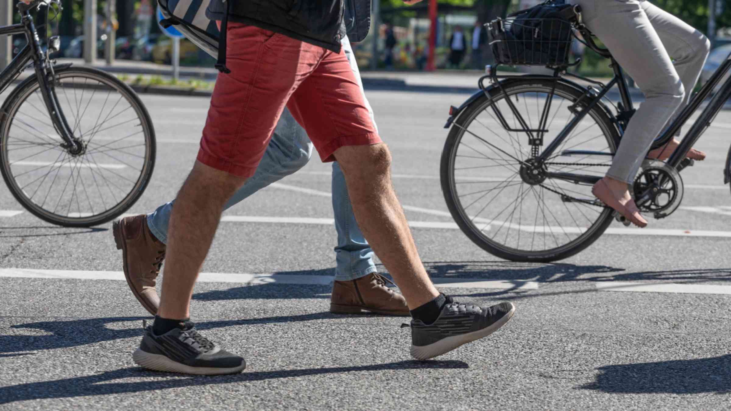 Pedestrians walk among bicyclists