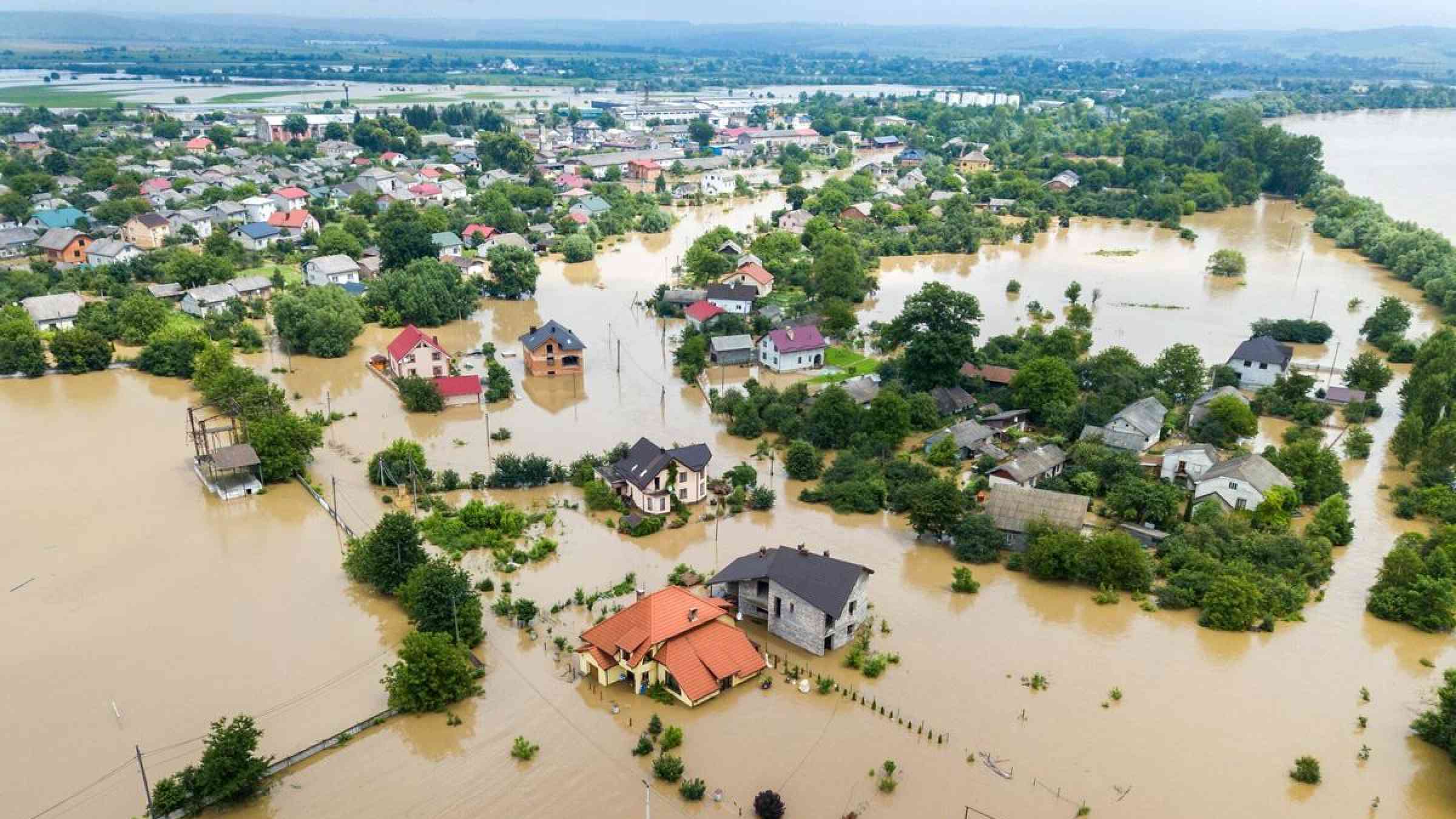 Aerial view of flooded houses with dirty water of Dnister River in Halych town, western Ukraine