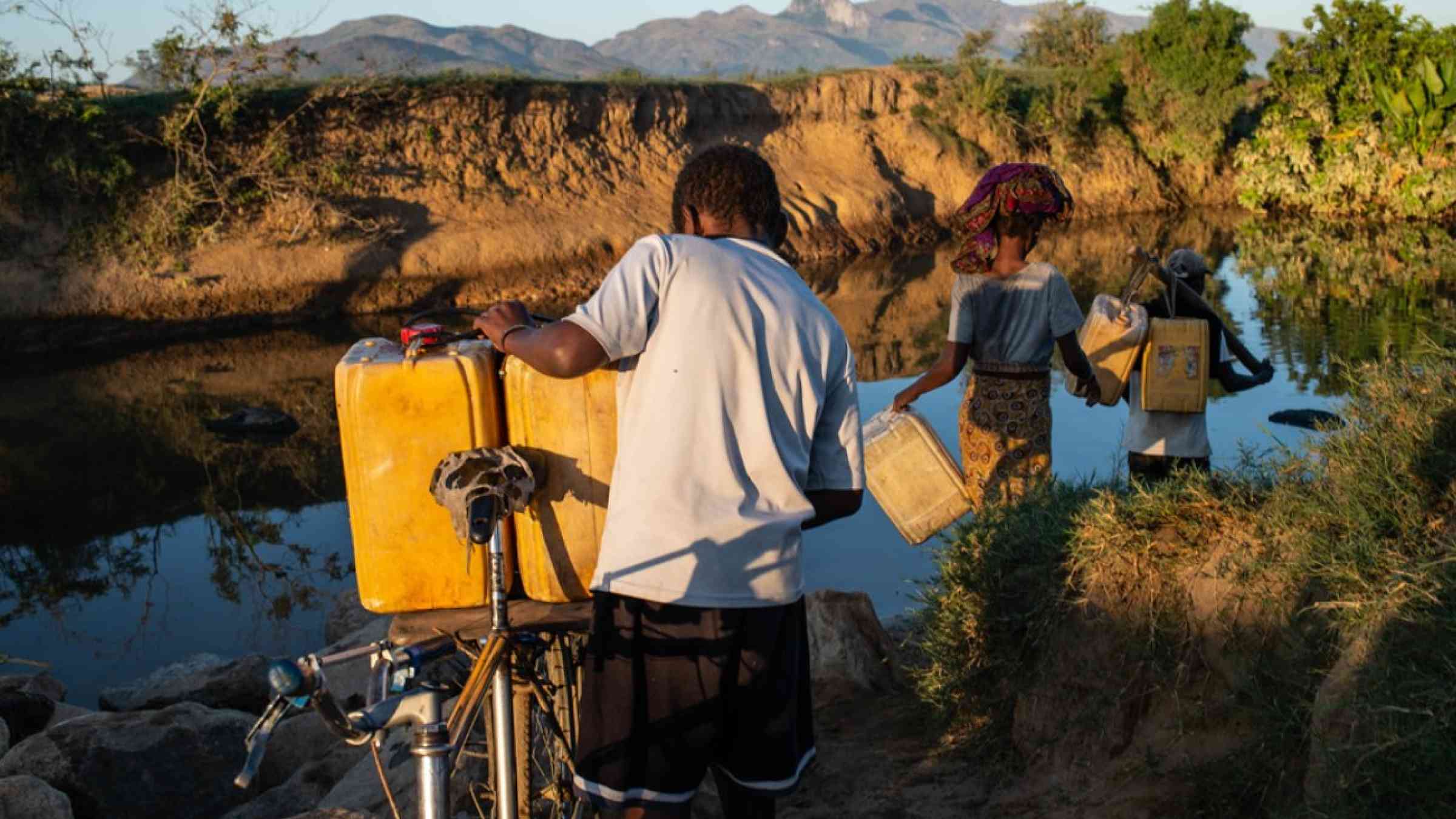A family fetches water from a stream during a drought in Madagascar