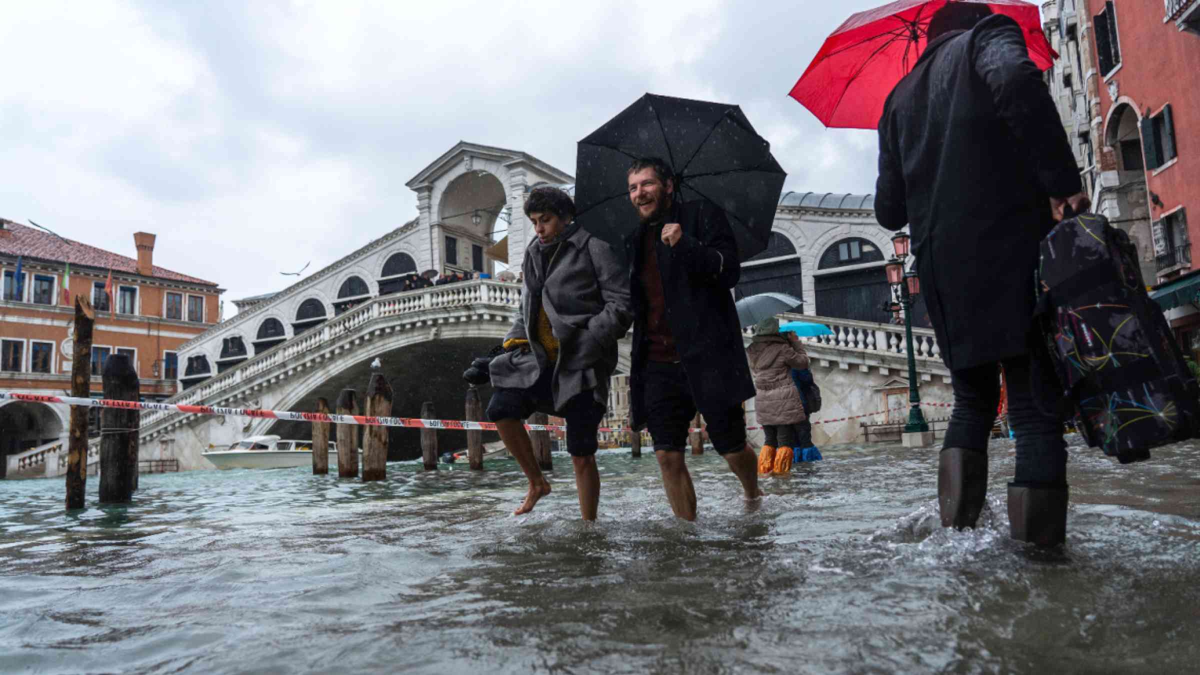 Tourists in Venice wade floods in 2019