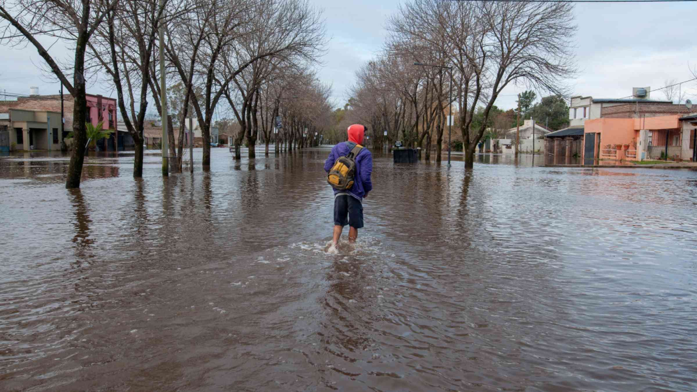 A man wades through the flood in Buenos Aires, Argentina
