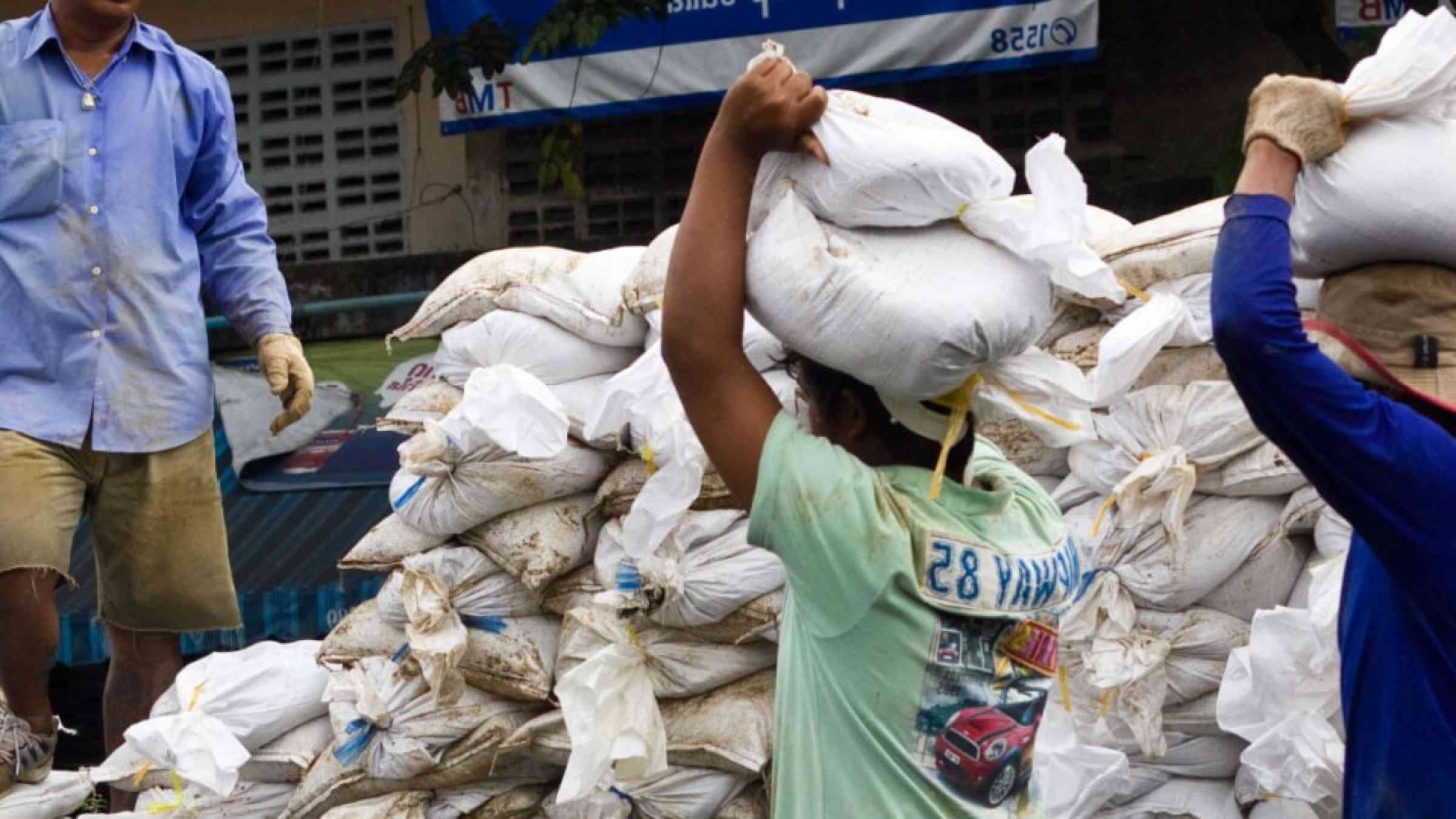  People bringing sandbags to prevent flooding in Bangkok, Thailand