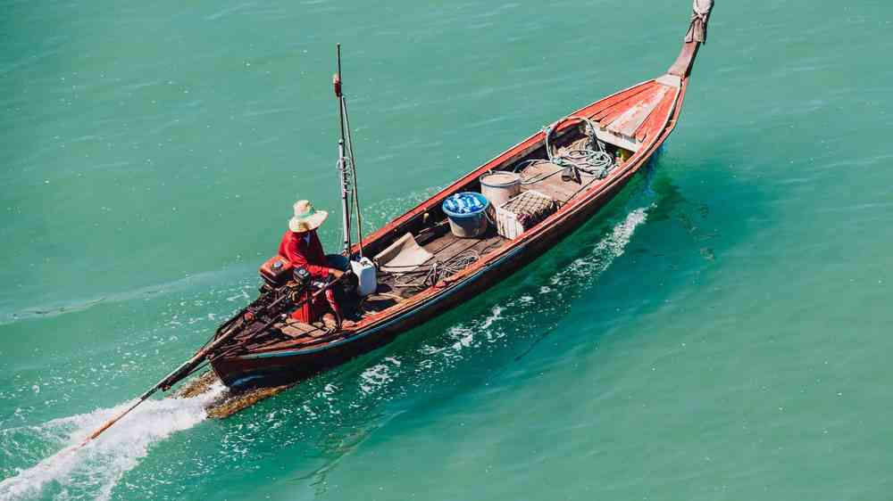 Local fisherman heading long tail boat to the pier at Koh Libong island, Trang province.