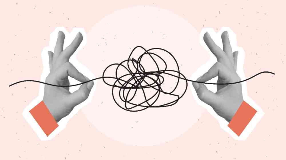ands pulls a thread from a tangled ball. Concept of problem solving and eliminating uncertainty.