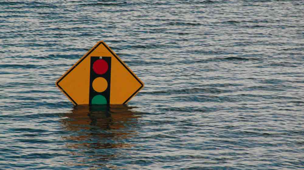 Flooded traffic sign partially submerged in water