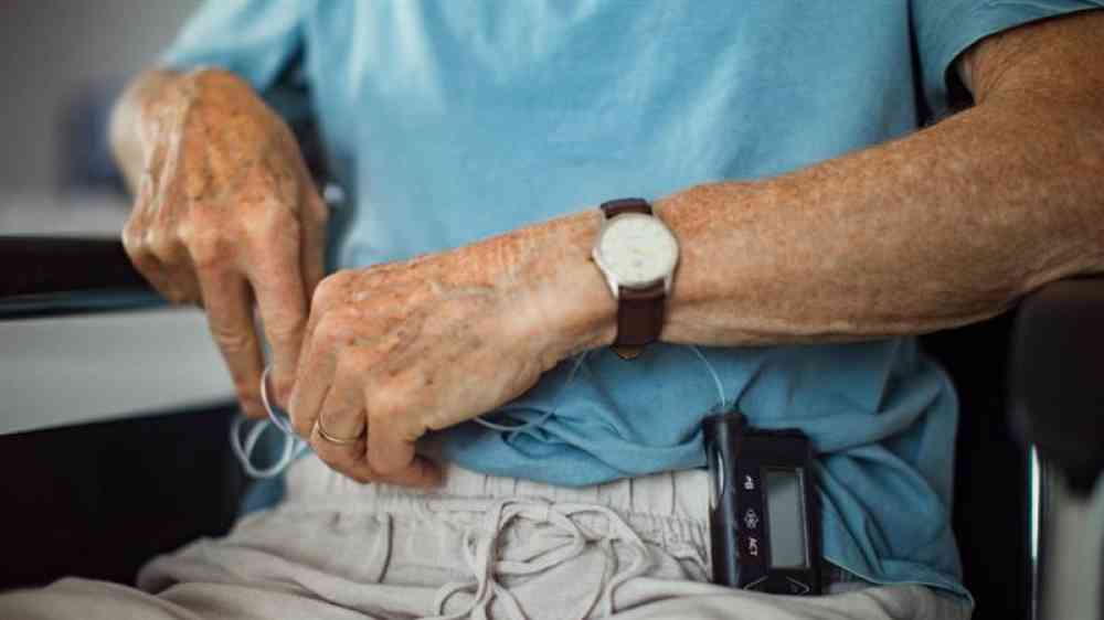 An older man with a glucose monitor