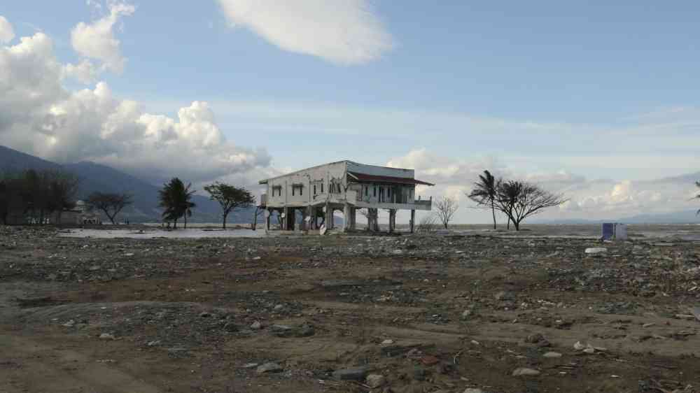 Damage after 2018 Sulawesi earthquake and tsunami, with one lone building in an empty landscape