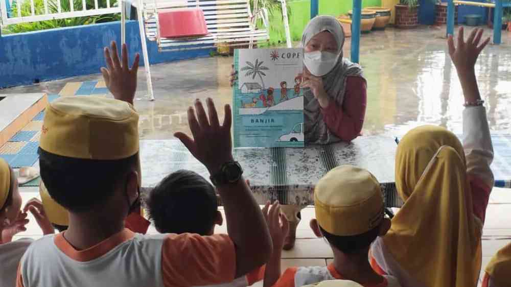 COPE Disaster Champions being taught to children