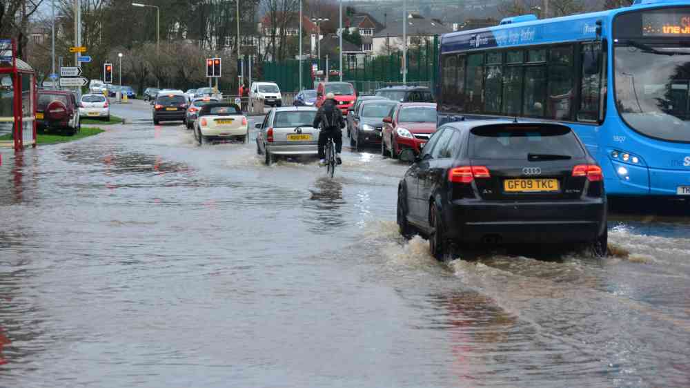 A flooded road with vehicles