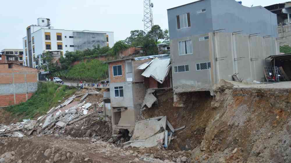 Severely damaged urban buildings after a landslide in showcasing destruction.