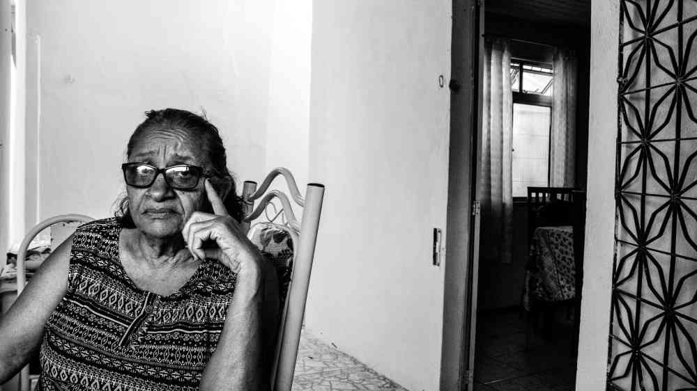 An older woman alone at home.