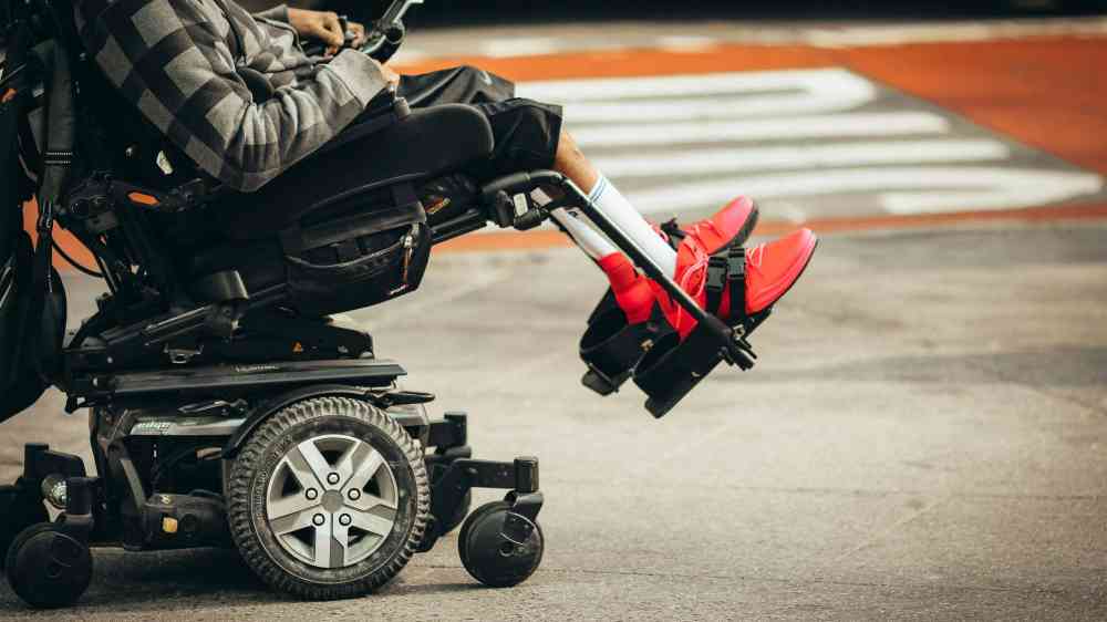 Person with disability on a motorized wheelchair