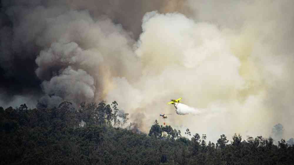 Firefighting aircraft extinguishing a forest fire in Sever do Vouga, Portugal.