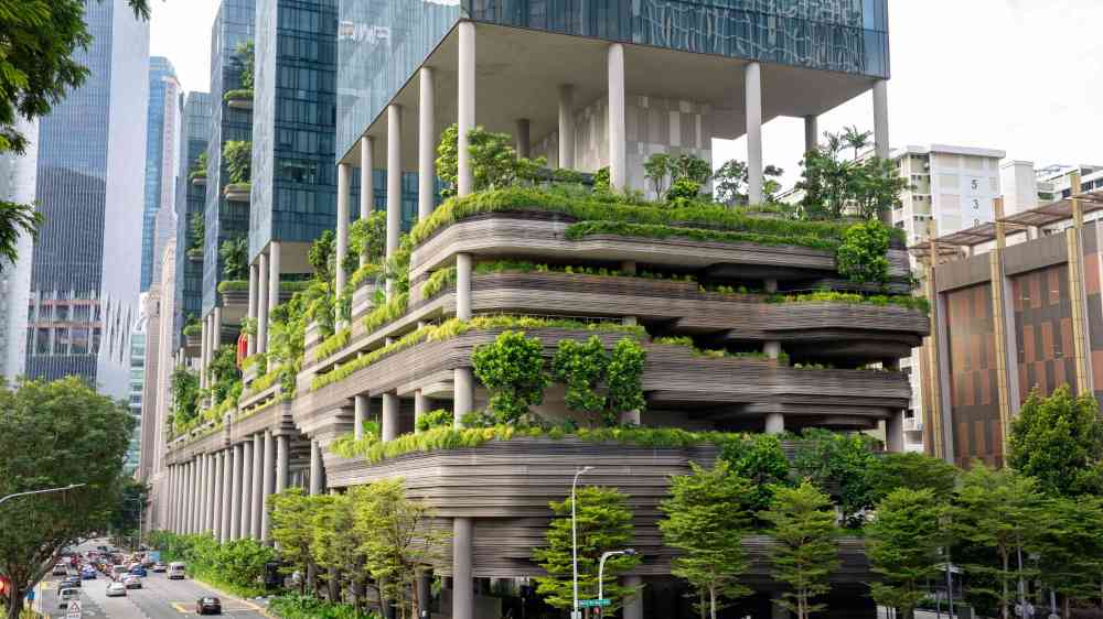 Modern high-rise with vertical garden, showcasing urban sustainable design.