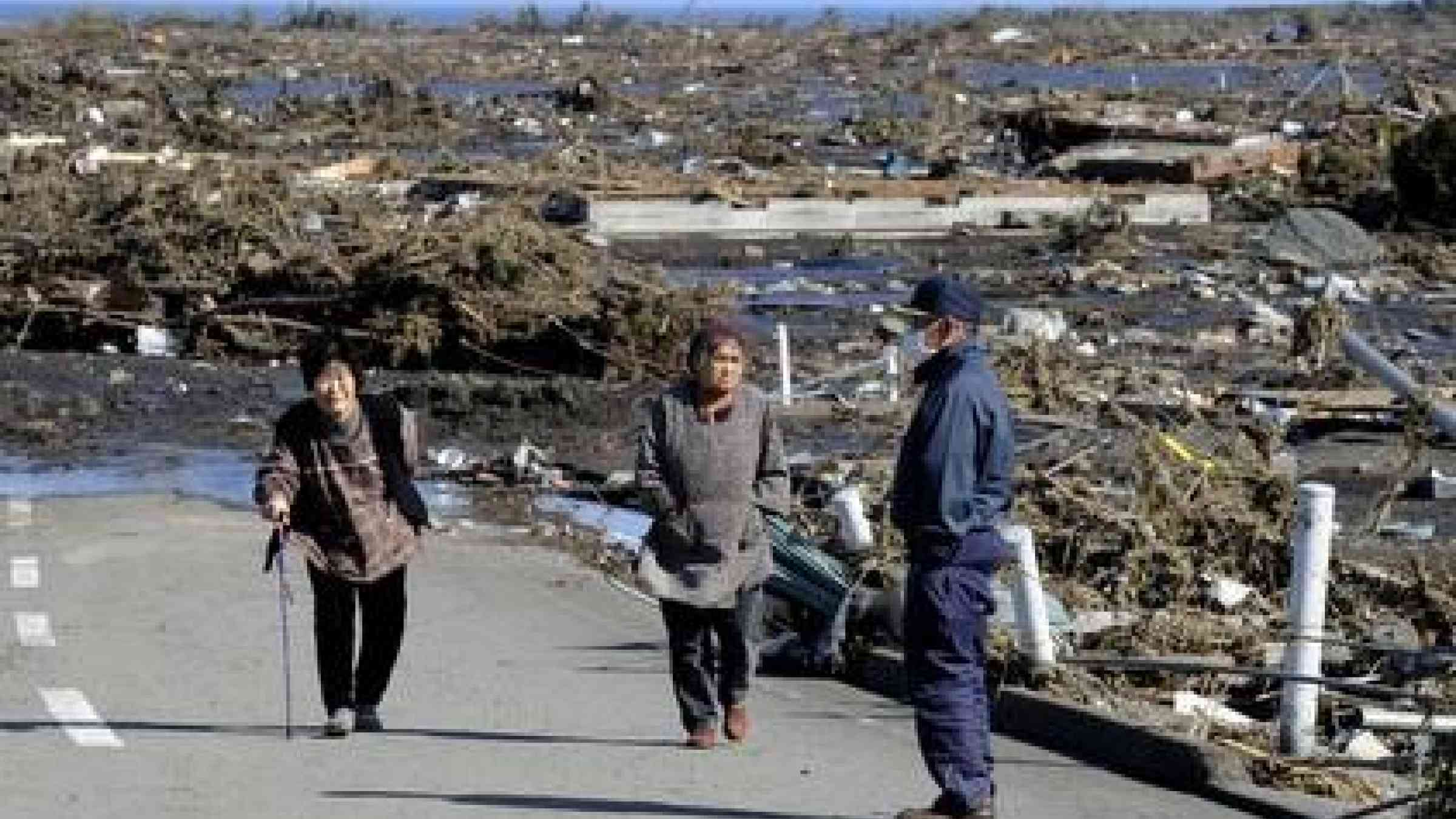 Elderly people look at the extensive damages from the tsunami in Minamisoma, Fukushima Prefecture on March 12, 2011 (Photo: TORU YAMANAKA/AFP/Getty Images)