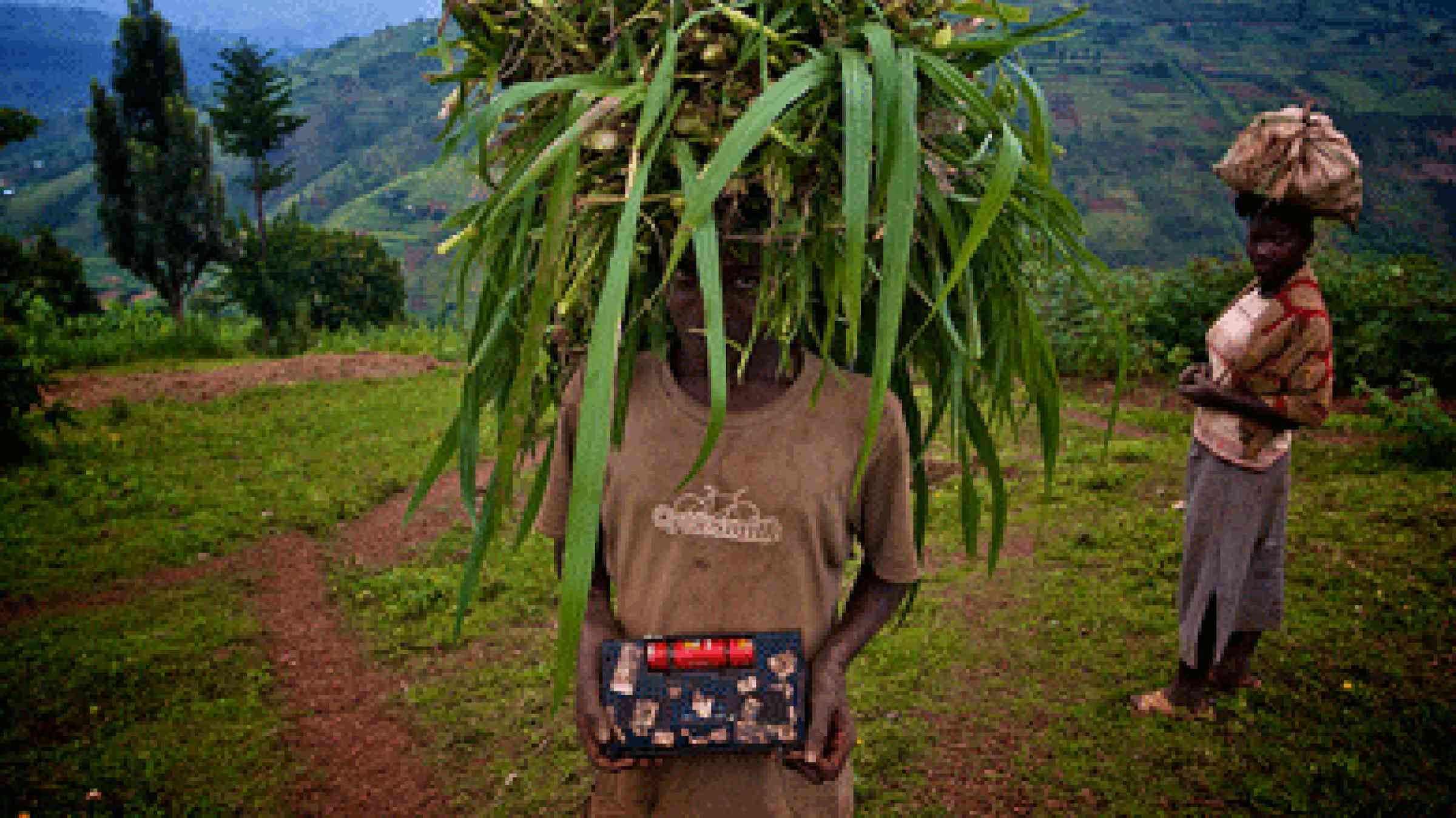 Photo by  Graham Holliday, Flickr user noodlepie: Listening to the radio on a mountain in Rwanda  Bumped into this guy halfway up a mountain in Gicumbi province in northern Rwanda. Carrying cattle feed on his head and listening to the radio in his hands. Read more about this part of Rwanda and gold exploration in the area kigaliwire.com/2011/12/07/hunting-for-gold-in-rwanda/ CC BY-NC 2.0, https://www.flickr.com/photos/noodlepie/6465765237