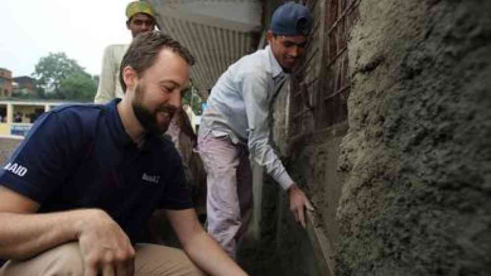 Photo by Flickr user Department of Foreign Affairs and Trade Mr Ben Reese, AusAID representative learns first-hand the processes of reconstructing a school building in an effort to make it more earthquake proof. CC BY 2.0 https://www.flickr.com/photos/dfataustralianaid/10703119813/