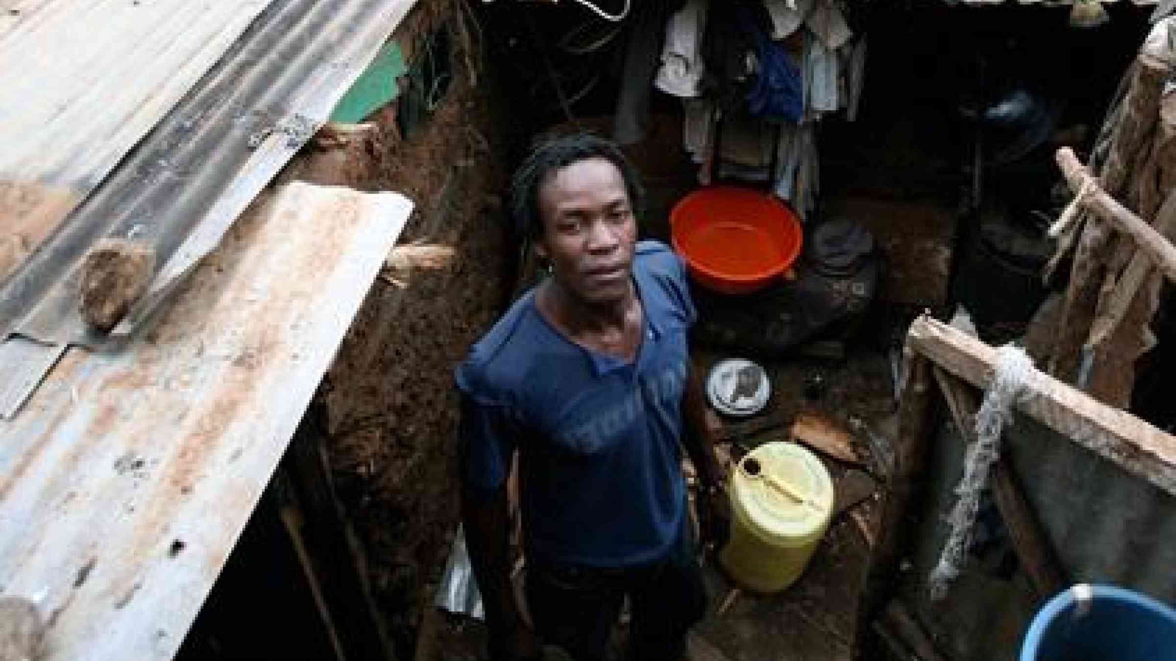 A man stands in front of his dwelling in Nairobi’s Kibera slums. (Photo: David Gough/ IRIN)