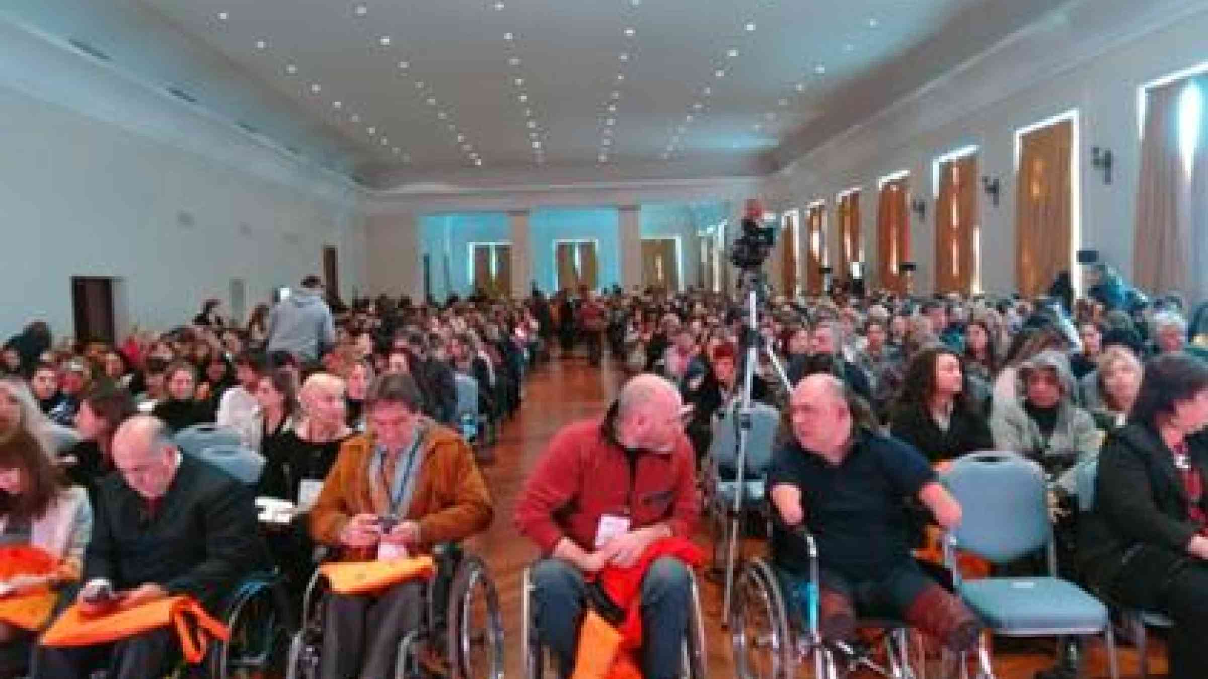 Participants in the PISEC launch discuss and check details of the plan. Front row, from left to right: Maria Lucia Ojeda Gutierrez, National Council of Disability Equality, Ecuador; Germán Xavier Torres, Vice President, National Council of Disability Equality, Ecuador; Ricardo Latorre of Argentina; Gerardo Burgos, Secretary of Sports, Buenos Aires; and Carlos Kaiser, Inclusiva. (Photo: Loreto Brossar/ Inclusiva)