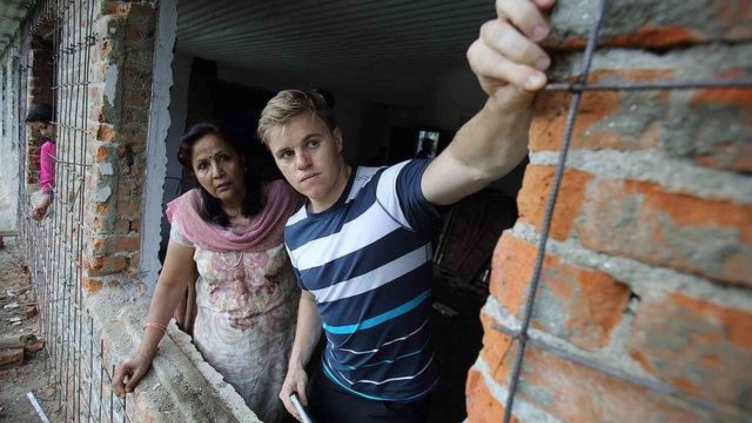 Bryce Harris, an AVID works with NSET seen here with Ms. Bhubaneswari Parajuli, an Australian Alumni, is the Gender, Social and Environmental Management Specialist at the National Society for Earthquake Technology Nepal (NSET). They are inspecting the reconstruction of a school building, in an effort to make it more earthquake proof Kathmandu, Nepal. Photo by Jim Holmes for AusAID. (13/2529), CC BY 2.0, https://www.flickr.com/photos/dfataustralianaid/10678260604