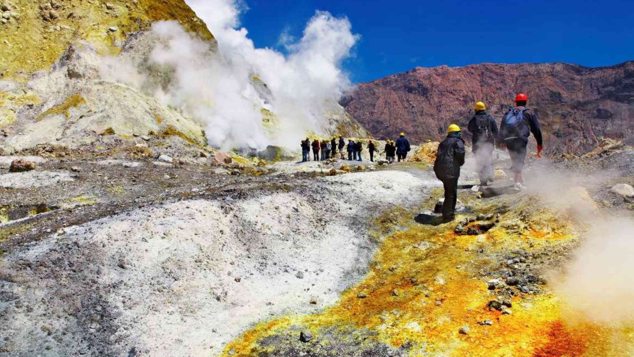People inside active volcanic crater, White Island volcano, New Zealand. Shutterstock/Dmitry Pichugin