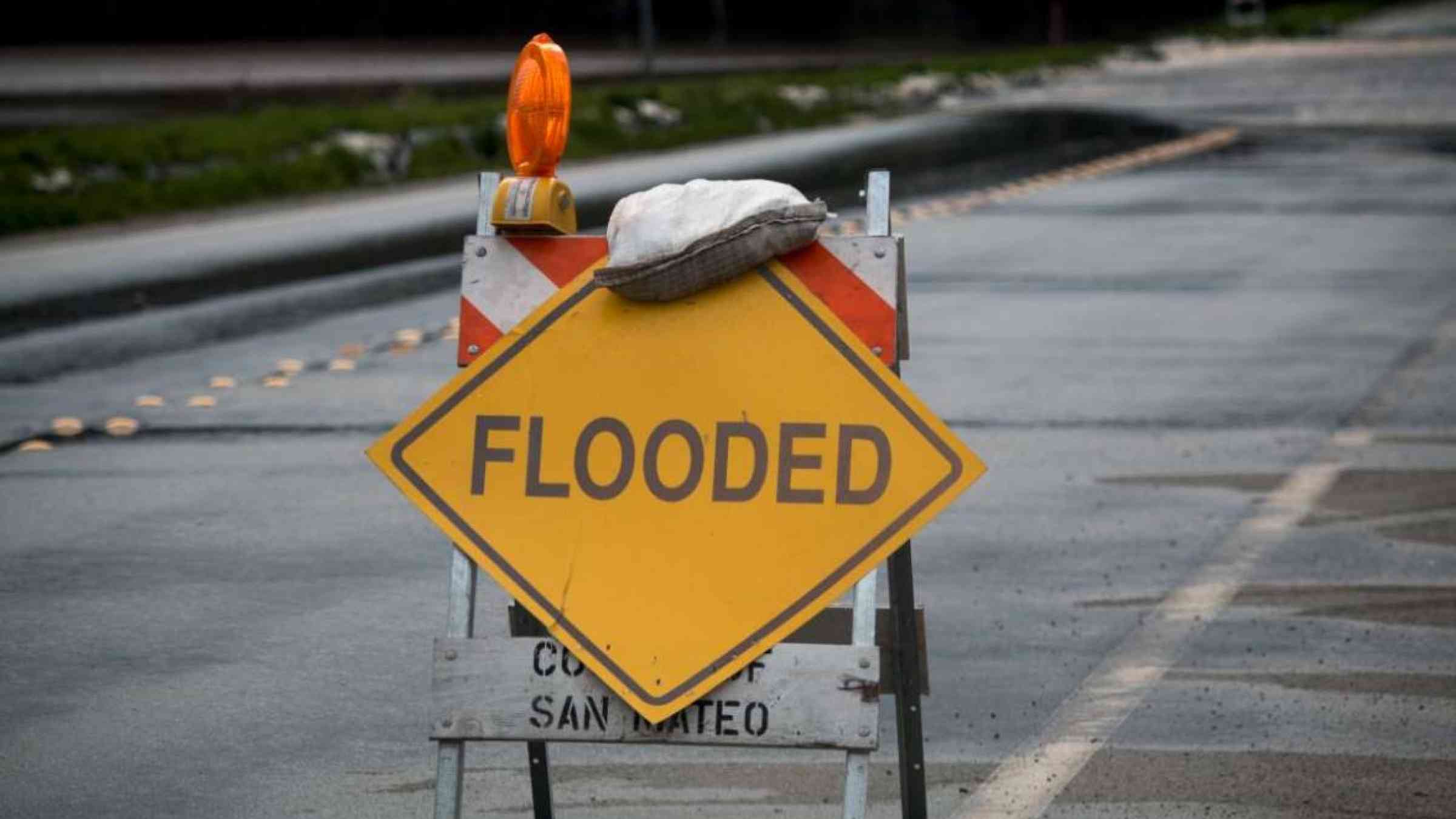 Flooded road sign in Pescadero, San Mateo County, California. Shutterstock.com