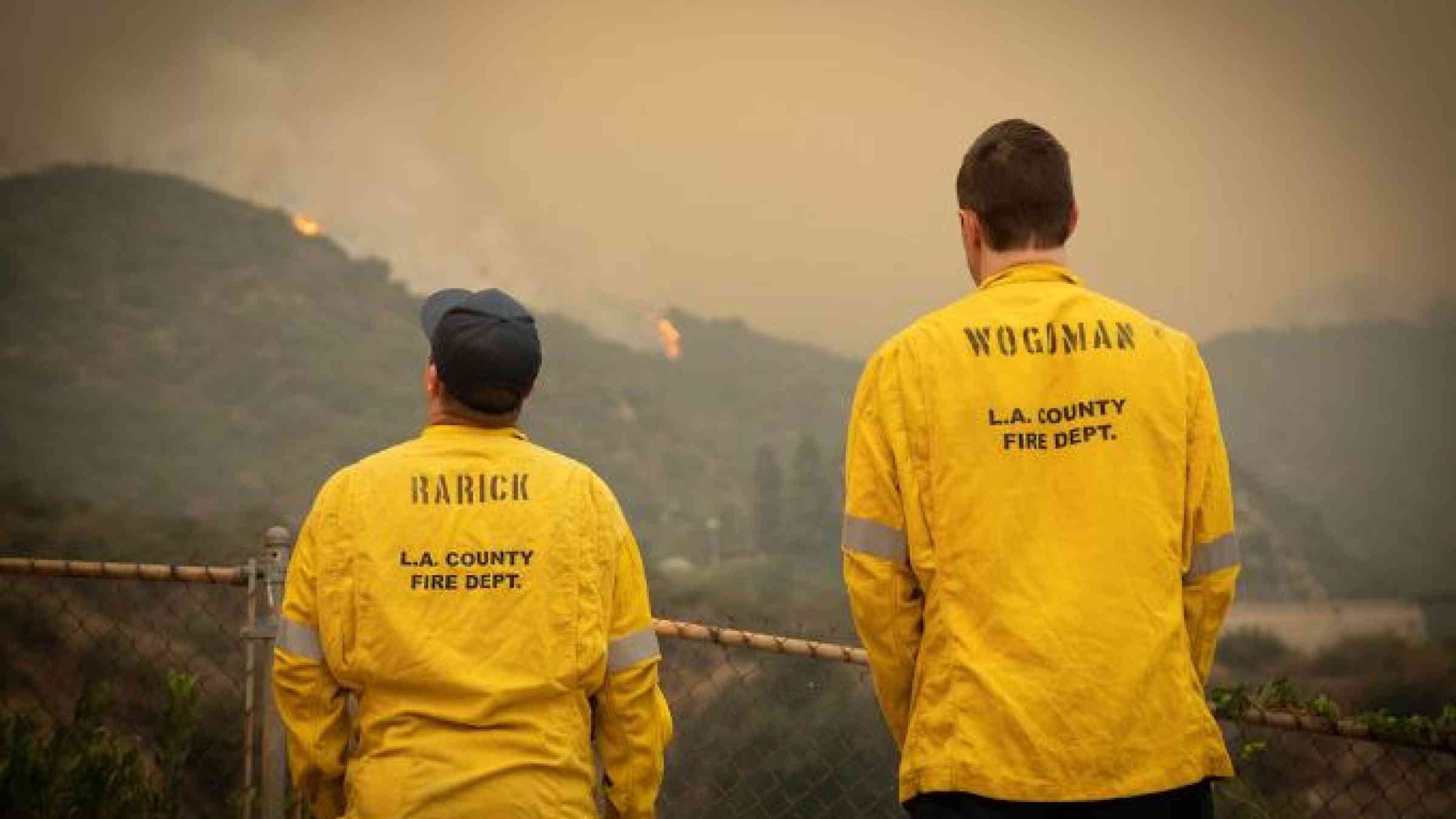 Monrovia, California / United States - September 11 2020: Los Angeles County Fire Department Fire Fighters Take a Break and Reflect While Looking Back at the Bobcat Fire in the Angeles National Fire. Emmett Reiner/Shutterstock