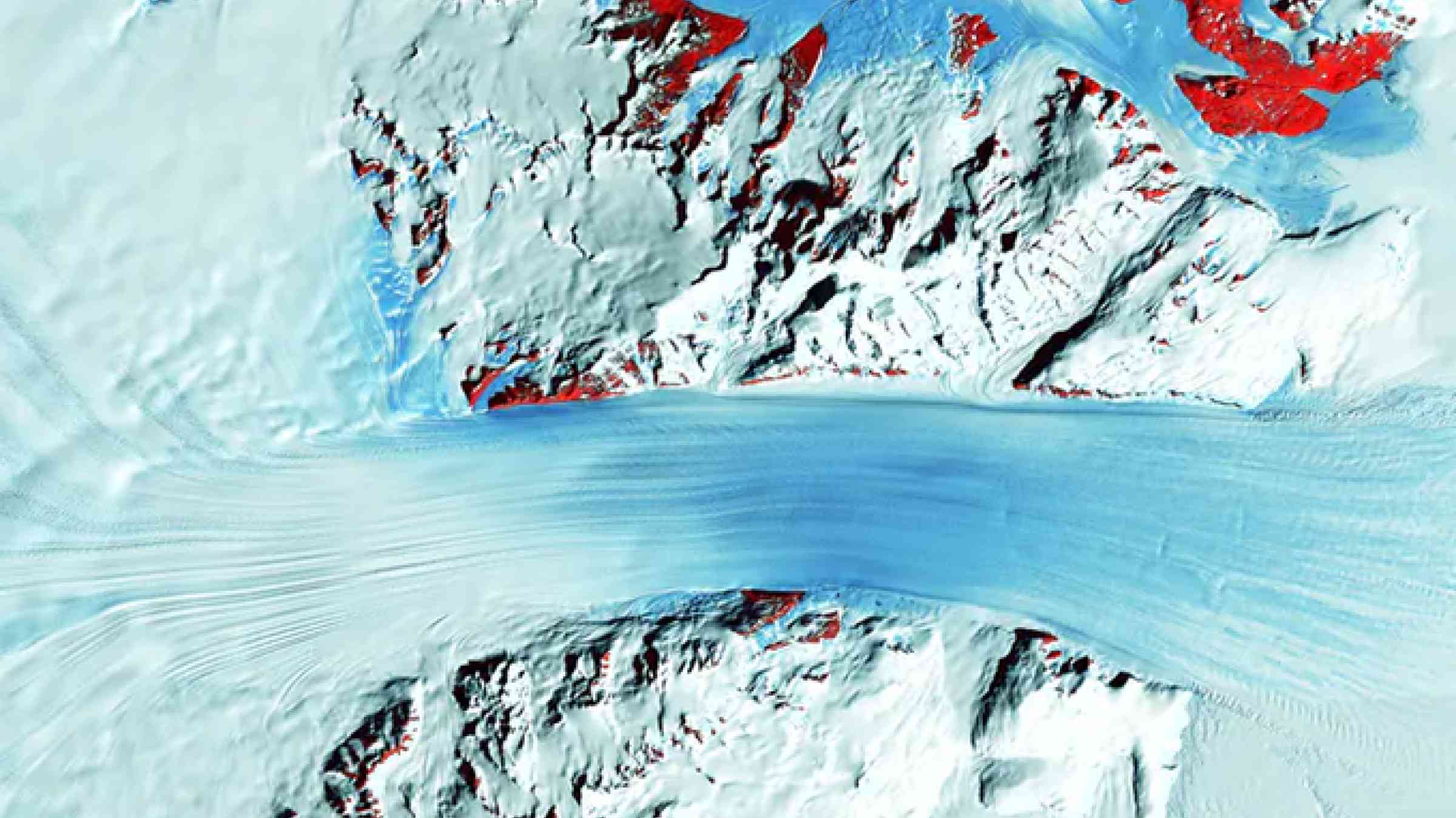 A satellite image shows the long flow lines as a glacier moves ice into Antarctica’s Ross Ice Shelf, on the right. The red patches mark bedrock. USGS