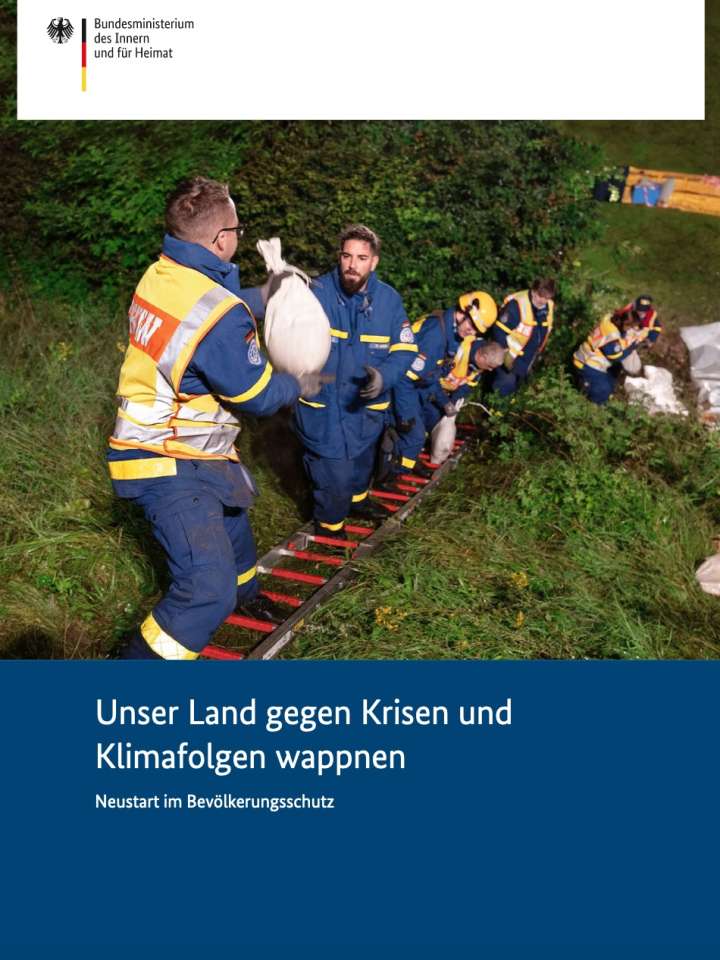 Cover page of the strategy: chain of disaster responders carrying sandbags